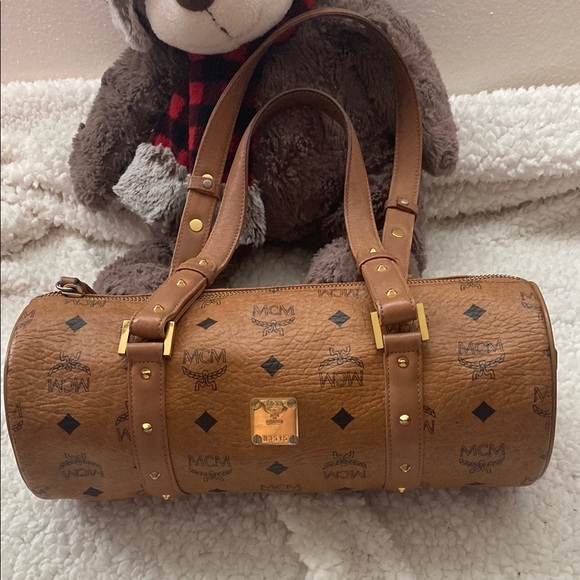MCM Handbags - MCM Tan Monogram Cylinder Bag with Gold Details